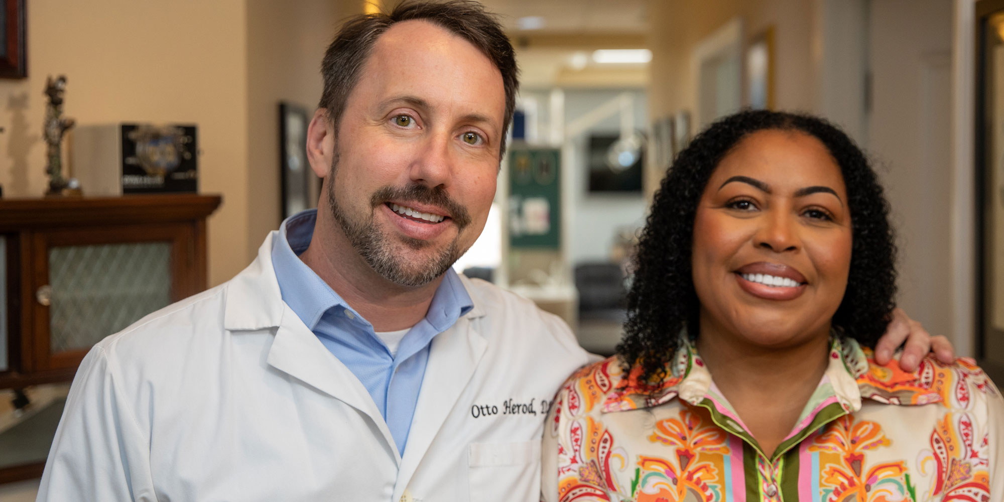 Patient and doctor smiling together