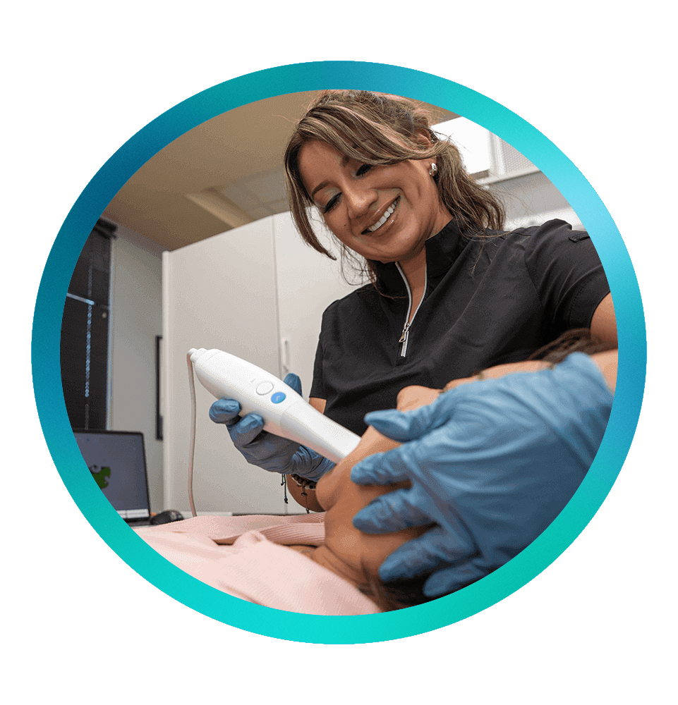 staff member performing an examination on dental patient